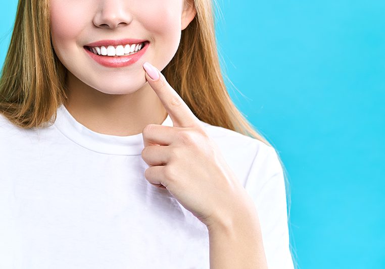 Perfect healthy teeth smile of a young woman. Teeth whitening. Dental clinic patient. Image symbolizes oral care dentistry, stomatology